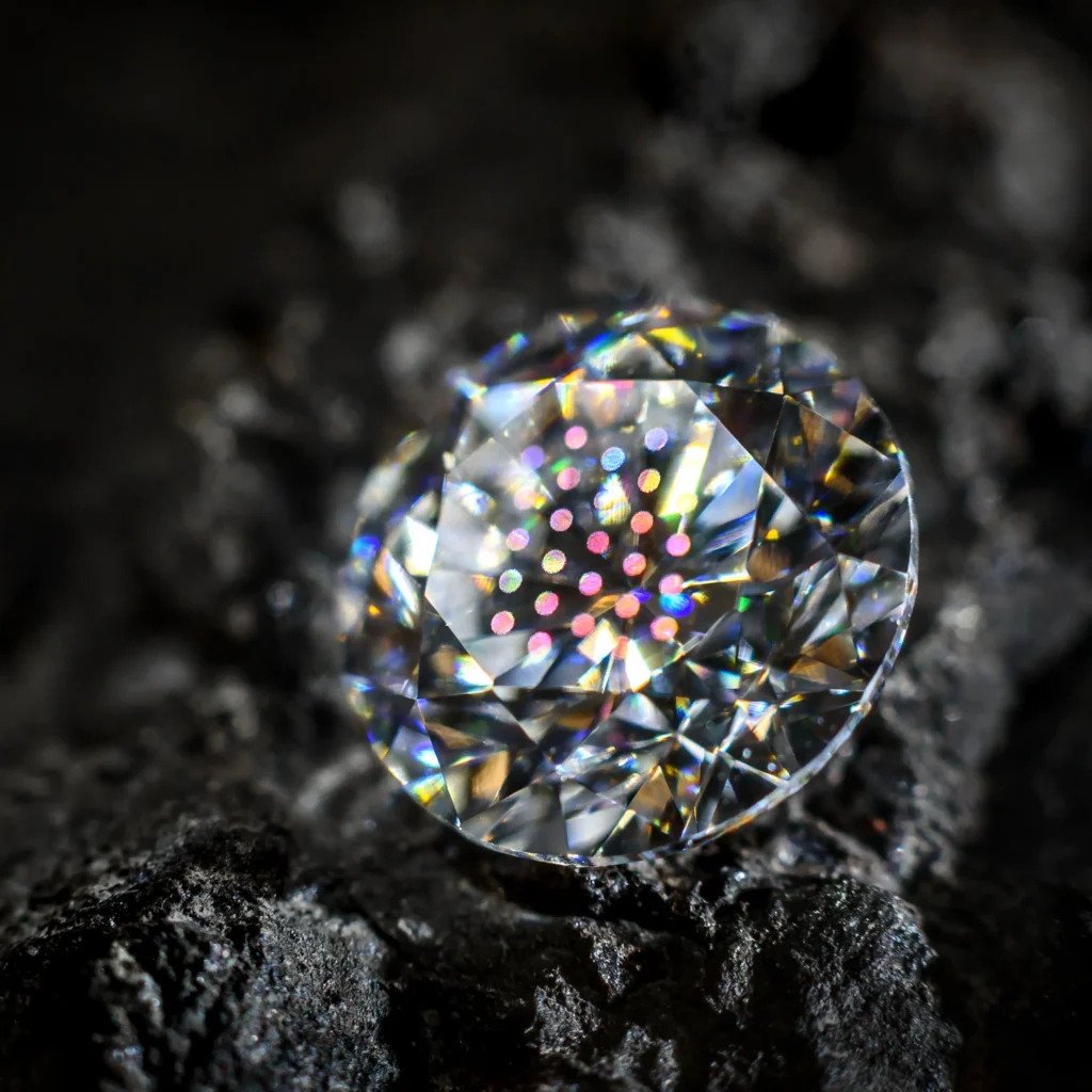 Diamond personalized by Arteida. Microscopic optical structures on the diamond's surface, visible against a dark coal background